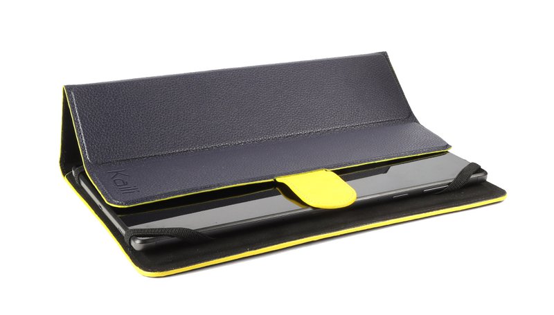 K0033DB | Étui pour tablette Cuir véritable, pleine fleur, grain dollar. Col. Bleu avec bords jaunes. Fermeture par patte contrastée. Dimensions : 19,5 x 25,2 x 1 cm Conditionnement : sachet Tnt
