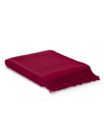 Soft, cozy throw blanket in a warm sunset color palette with a textured woven pattern and fringe trim.