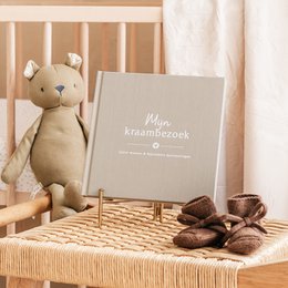Linen taupe maternity visit book with text "Mijn kraambezoek" (My maternity visit) on the cover.