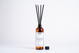 Refillable diffuser pack with 7 unique fragrance blends including Cassis & Fig, Grapefruit & Gardenia, Lime, Amber, Velvet Rose & Oud, Peonies & Pink Pepper, and Vanilla & White Musk. Diffuser comes in a glass bottle with black reed sticks.