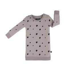 A gray baby dress with a pattern of black polka dots. The dress has long sleeves and a simple, minimalist design.