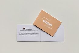 A greeting card with the text "You are worth gold" printed on a peach-colored background.
