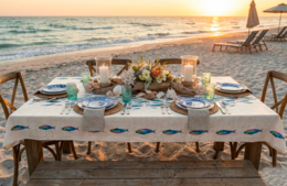  Rectangular tablecloth with sardine print, available in 160x250 cm and 160x300 cm sizes, suitable for outdoor beach dining at sunset.