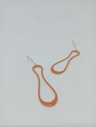Orange enamel drop earrings with a teardrop shape and gold-tone hardware.