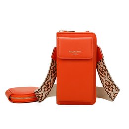 A compact, cross-body phone bag in a vibrant orange color with a flap closure and a detachable woven strap for hands-free carrying.