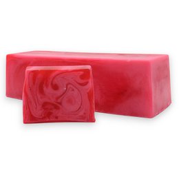 Red swirled decorative soap loaf with ornate pattern, sliced into bars.