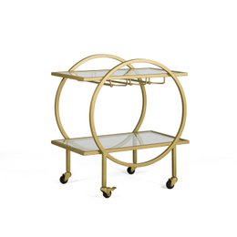 A round, gold-colored metal wine rack with two glass shelves and wheels for mobility. The design features a circular frame with a curved handle on top.