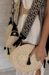 Woven shoulder bag with tassel accents, available in multiple colors including black, olive green, pink, blue, grey, lime, and lilac.