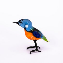 Colorful glass figurine of a kingfisher bird, a small perching bird with a long, sharp beak and vibrant blue, orange, and green colors.