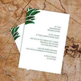 This card features a minimalist design with green leaf-like shapes on the corners, creating a natural, earthy aesthetic. The text on the card appears to be a message or invitation, though the specific details are not visible in the provided image.