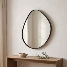 Organic pebble shaped wall mirror, black metal frame, round irregular oval form, modern minimalist design.