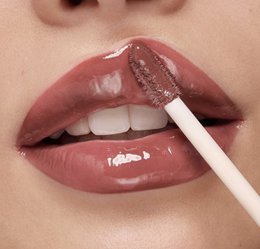 Brownie-colored lip gloss with a shiny, glossy finish. Provides a natural, hydrating tint for the lips.