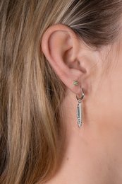 Silver feather charm with a delicate, minimalist design.