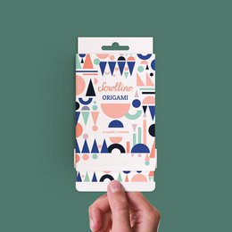 Scrollino Origami, a colorful arts and crafts product featuring various origami shapes and patterns in blue, pink, and white.