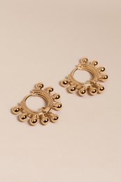 Gold hoop earrings with dangling beads, perfect for adding a touch of elegance to any outfit.