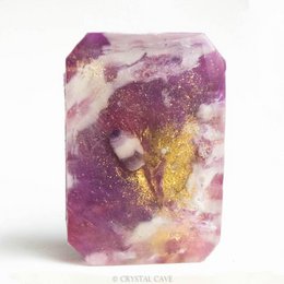 Amethyst-infused gemstone soap with a celestial dream design, featuring a vibrant purple and gold color palette.
