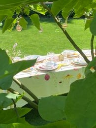 Rectangular tablecloth with a floral pattern featuring butterflies, flowers, and leaves in vibrant colors.