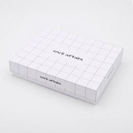  A gift box containing a variety of socks from the Sock Affairs brand. The box is white with the brand name printed on it.