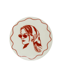 Terracotta dessert plate with a stylized illustration of a woman wearing sunglasses in a retro, vacation-inspired design.