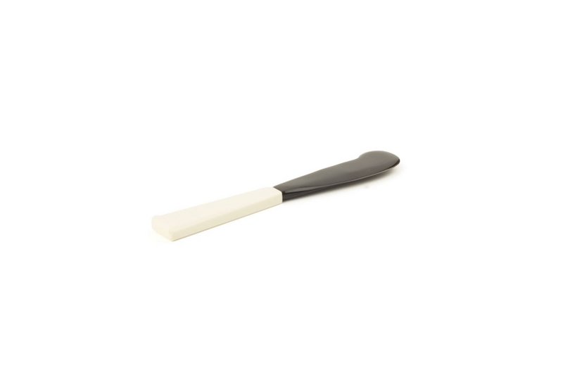 Butter knife with bone handle and black horn blade