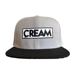 Grey and black snapback cap with "CREAM" text logo
The product is a grey and black snapback cap with the text "CREAM" prominently displayed on the front panel. The cap features a structured, six-panel design with a flat brim. The color combination of grey and black gives the cap a classic, versatile look that would suit a variety of casual outfits.