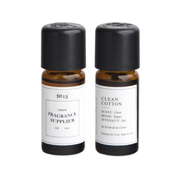 Clean cotton diffuser refill with a fresh, natural scent. Cylindrical glass bottle with black cap.