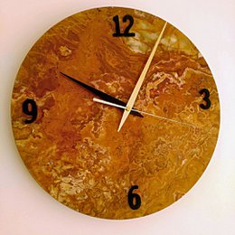 Round wall clock made of onyx stone with a natural, textured surface and contrasting black numbers.