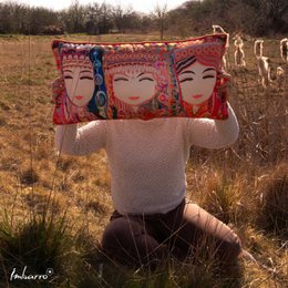 Decorative pillow with colorful Asian-inspired print featuring three smiling female faces. Rectangular shape, soft fabric material.