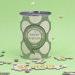 A puzzle with the message "Granny you're the best" in a glass jar, surrounded by puzzle pieces.