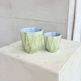 Stoneware medium poly cups in a minted lilac color with a textured, speckled pattern.