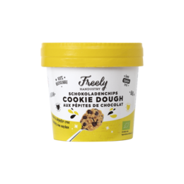 Chocolate chip cookie dough in a yellow container with a yellow lid. The product is labeled as "Creamy cookie dough" and appears to be a sweet, indulgent treat.