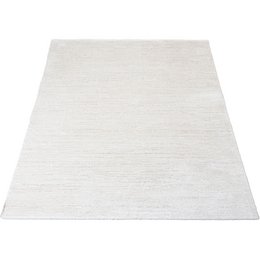Rectangular white rug with a textured, plush surface suitable for a child's room.