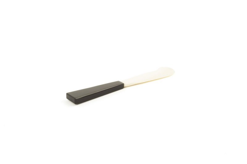 Butter knife with black horn handle and bone blade