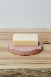 Rectangular pink soap dish made of ceramic material.