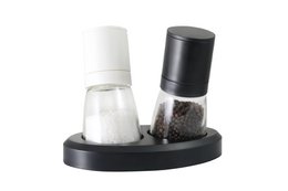 Set of salt and pepper mills in black and white colors, with a modern and minimalist design. The mills feature adjustable grinders for customizing the coarseness of the salt and pepper.