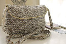  Gray shoulder bag with a repeating fan or scallop pattern in shades of gray. The bag has a flap closure and a detachable shoulder strap.