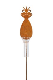 A whimsical frog-shaped rain gauge on a metal stake. The frog has a crown-like design on its head, adding a playful, decorative touch to this functional gardening tool.