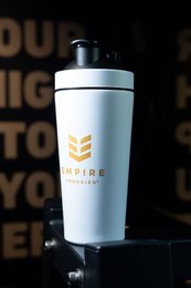 Stainless steel protein shaker bottle in white, up to 900ml capacity with mixing ball.