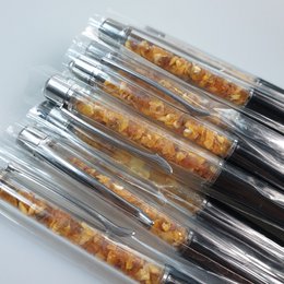 Amber-colored gemstone pen with a sleek, modern design, suitable as a gift for a boss or on Boss Day.