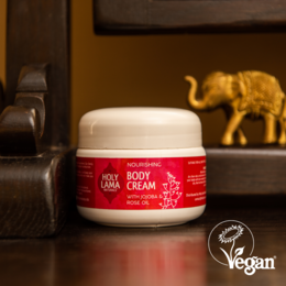 Nourishing body cream with jojoba and geranium oils, vegan formula, white jar with red label.