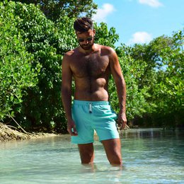 Mint green men's swimming trunks made of lightweight, quick-drying material. Features an elastic waistband and drawstring for a comfortable, adjustable fit. Available in sizes S, M, L, XL, and XXL.