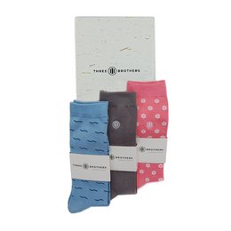 Springbox socks in a variety of patterns and colors including blue, gray, and pink with polka dots.