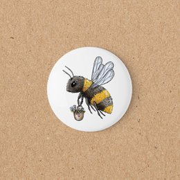 Bee magnet, yellow black striped insect, round white background, decorative home accessory.