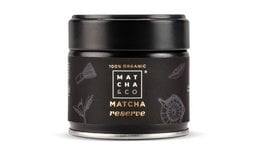 100% organic matcha tea powder in a black tin container with Japanese-inspired design elements.