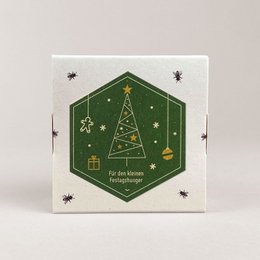 A box of assorted honey chocolates in various flavors including nut, mint, cinnamon, lemon, and coffee. The box has a festive holiday design with a green hexagonal pattern and white accents.