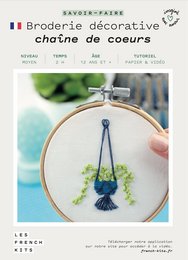 Decorative embroidery kit featuring a chain of hearts design. Includes embroidery hoop, thread, and instructions for a creative DIY project.