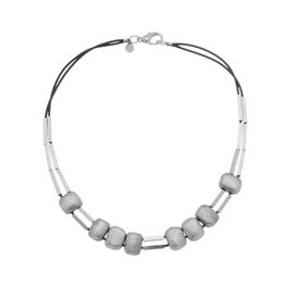 A short silver-toned necklace with a mix of round and cylindrical beads in a minimalist, modern design.
