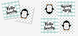 Mint green and black patterned napkins with "Hello lovely" text and penguin silhouettes.