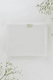 Soft, white muslin baby blanket with delicate pearl detailing.