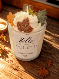 Scented candle with a warm, autumnal fragrance. Features a creamy white wax with orange and brown accents, evoking the colors of fall foliage. Topped with a decorative leaf.